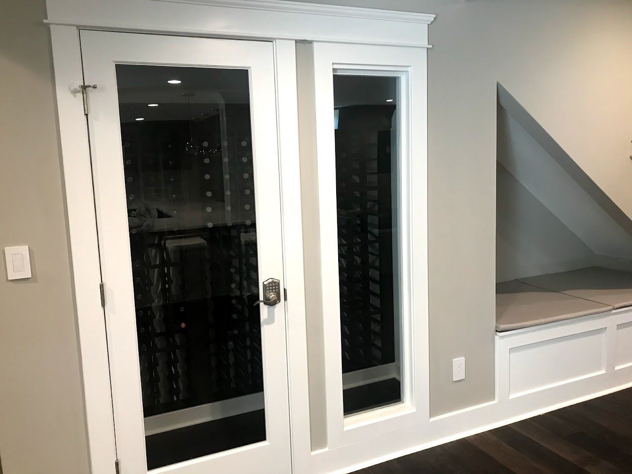 A room with a sliding glass door leading to a wine cellar.