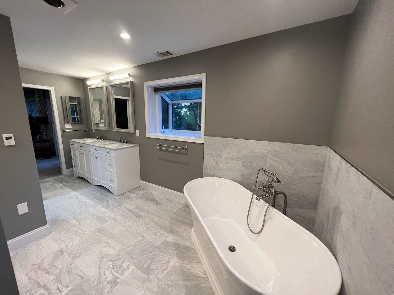 There is a bathtub in the middle of the bathroom.