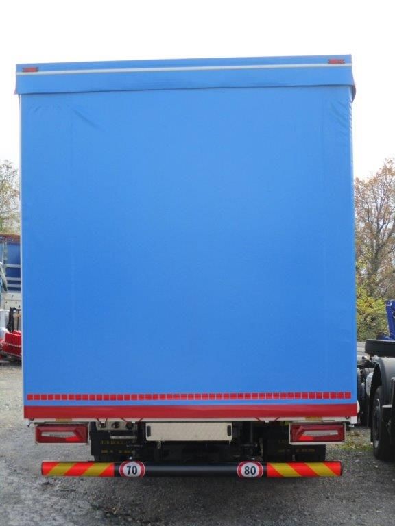 Vista posteriore di un semirimorchio blu con strisce riflettenti orizzontali rosse e bianche nella parte inferiore.