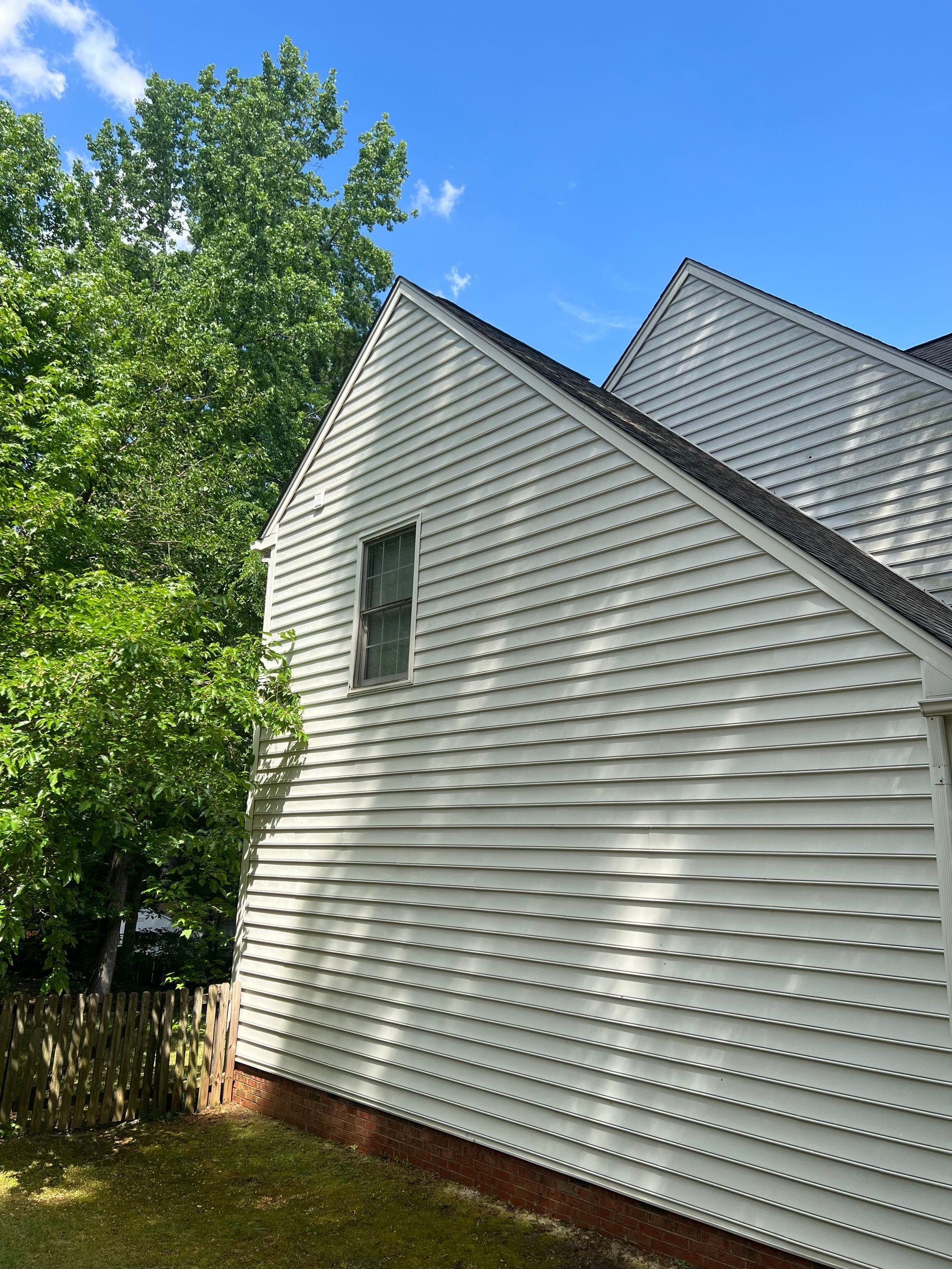 Side of house showing clean siding after residential pressure washing in Raleigh, NC