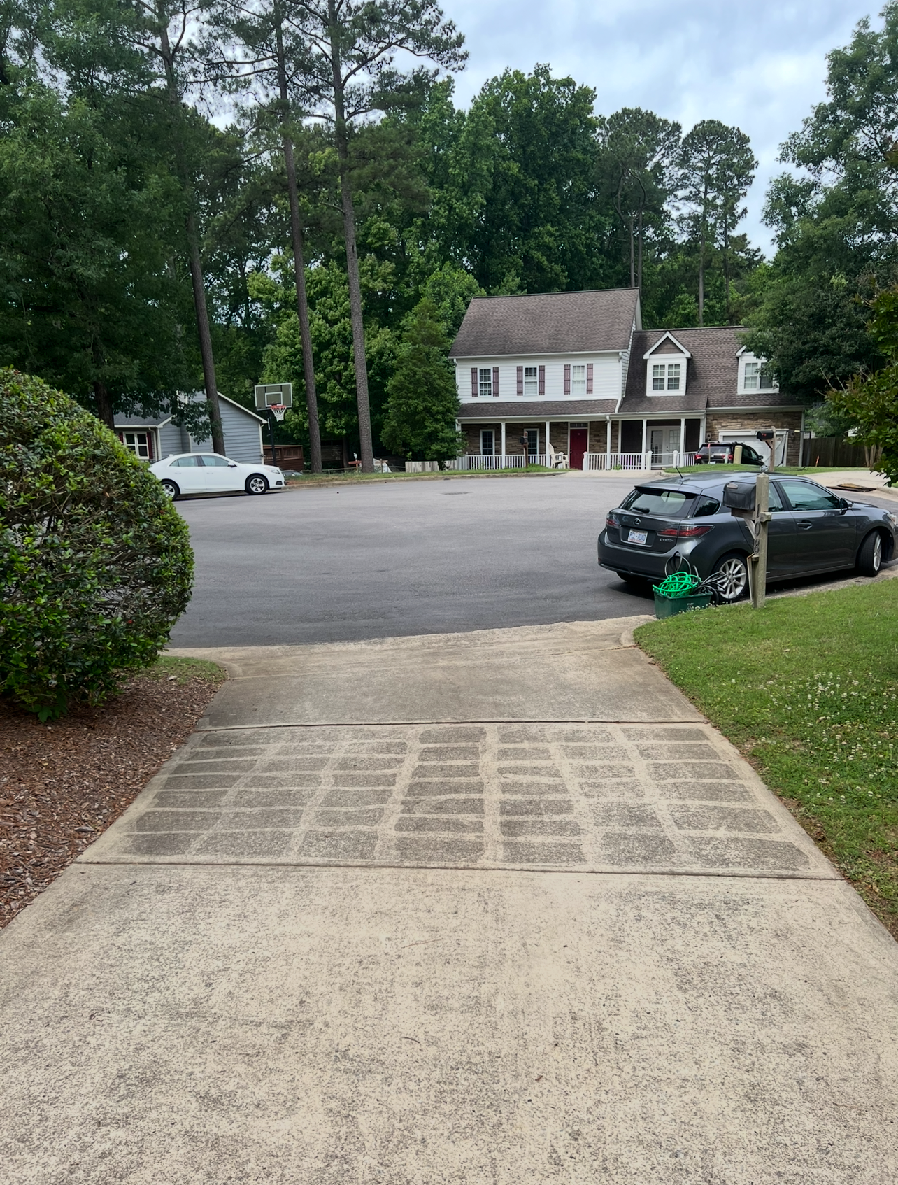 Driveway before pressure washing in Wake County, NC showing built-up grime and dirt