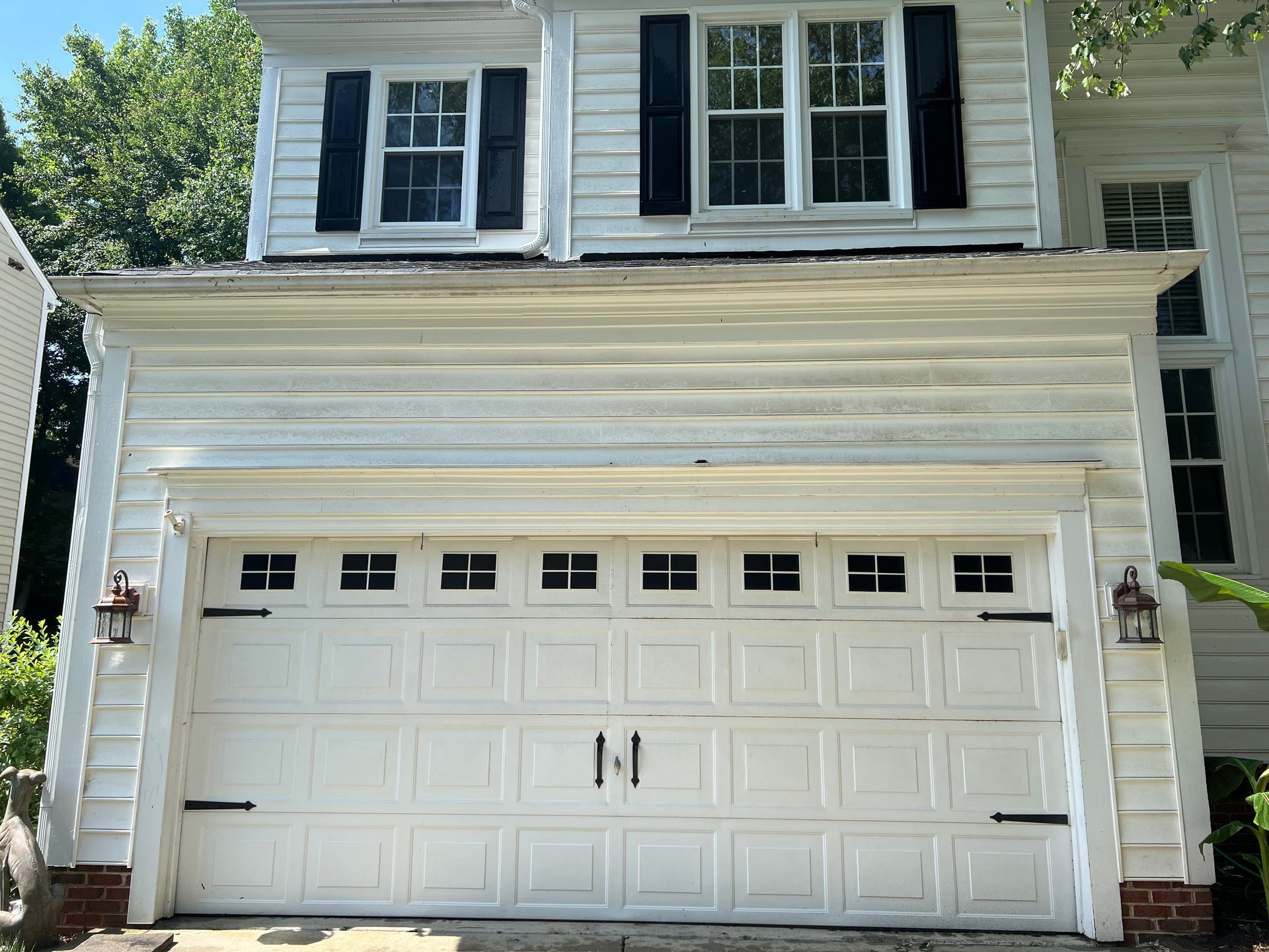 efore photo of garage exterior with buildup and discoloration in Cary, NC