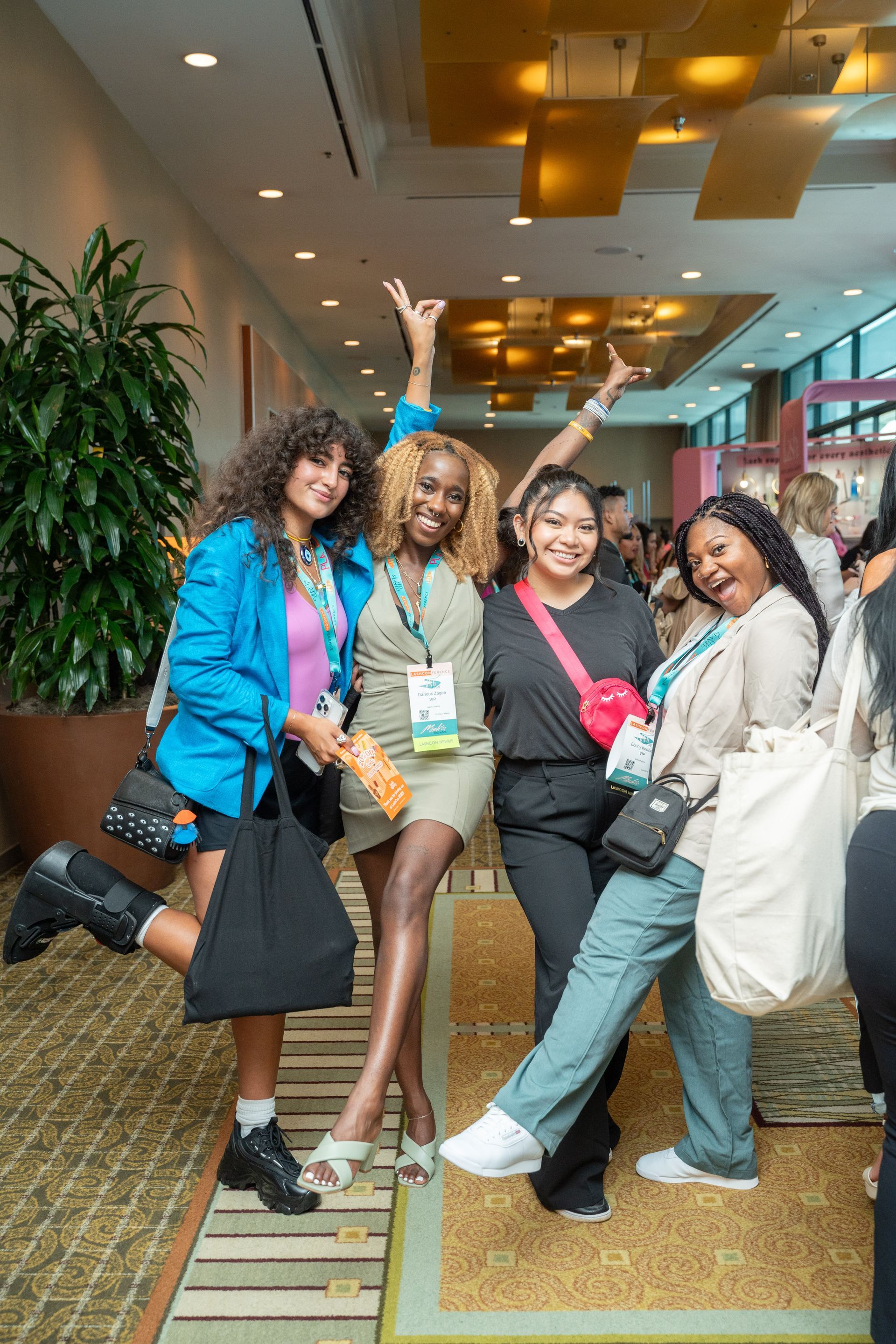A group of women are posing for a picture in a hallway.