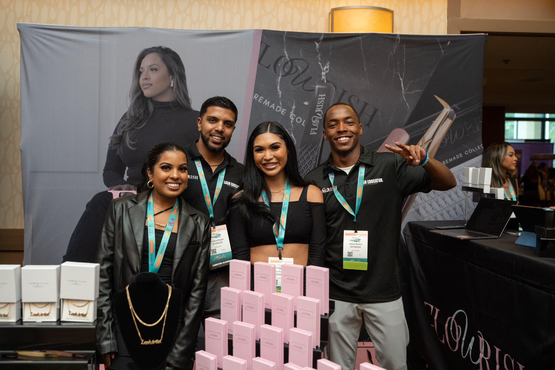 A group of people are posing for a picture in front of a wall.