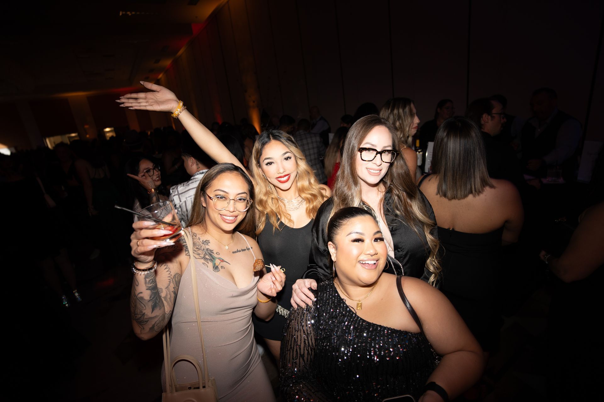 A group of women are posing for a picture at a party.
