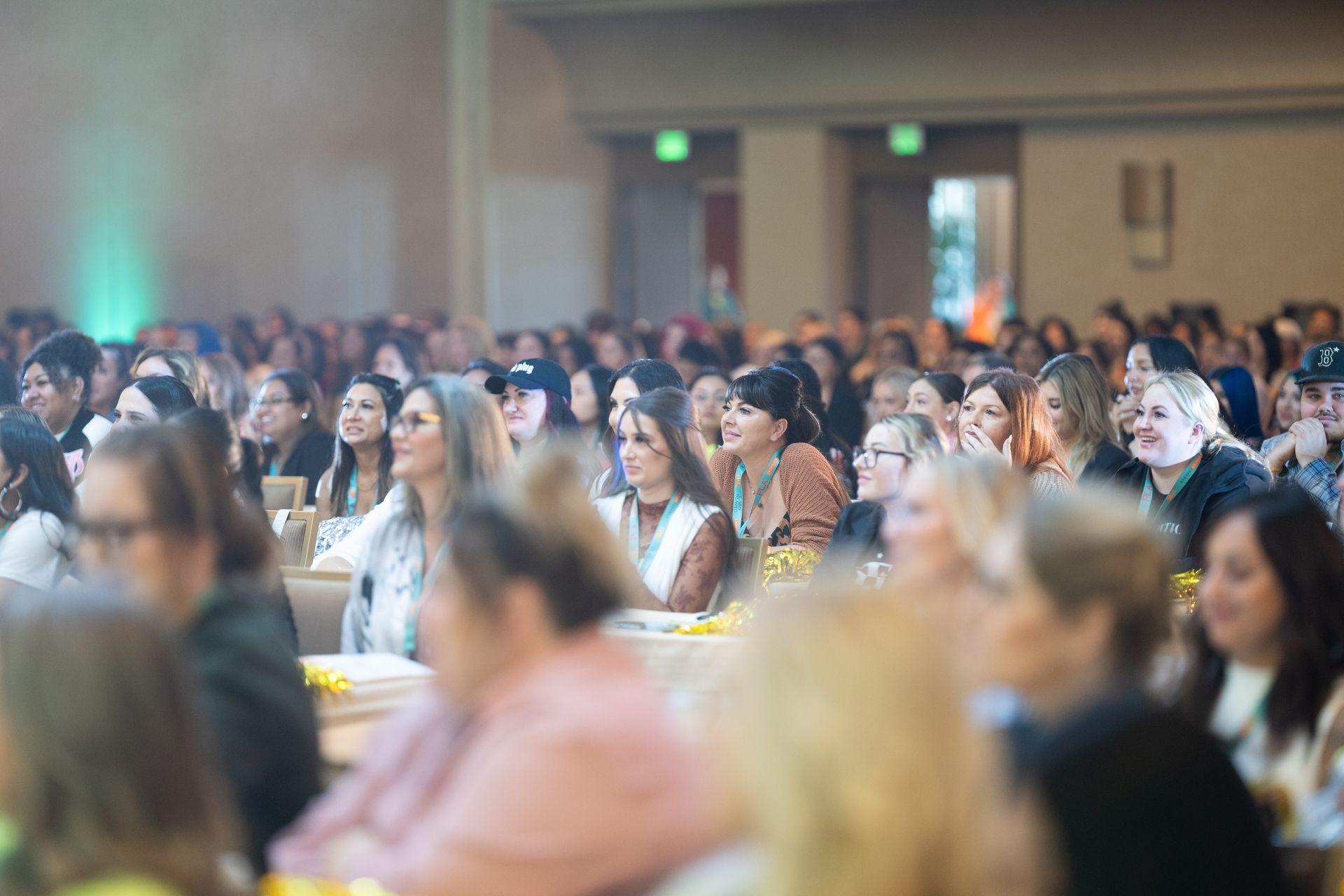 A large group of people are sitting in a room watching a presentation.