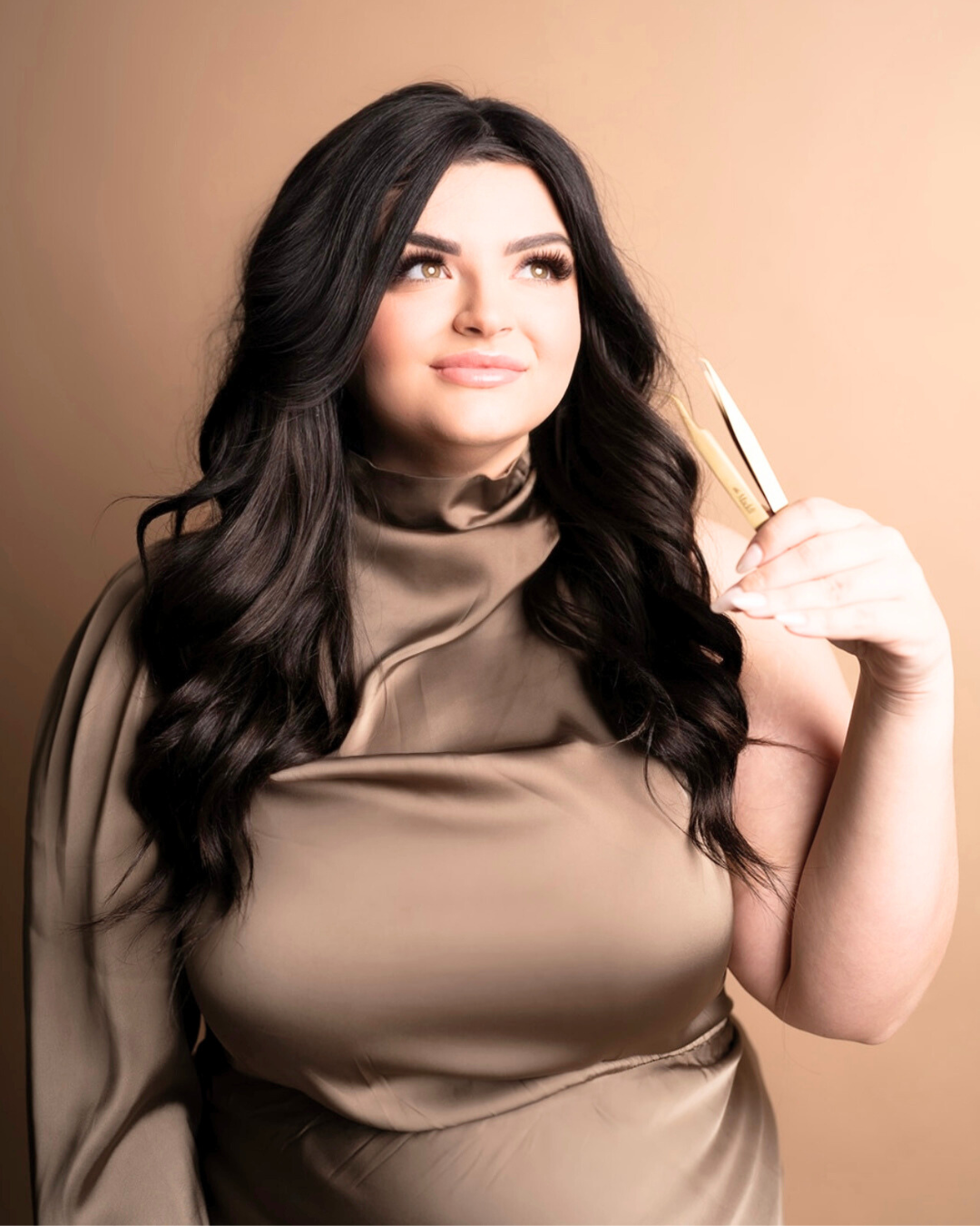 A woman in a brown dress is holding a pen in her hand.