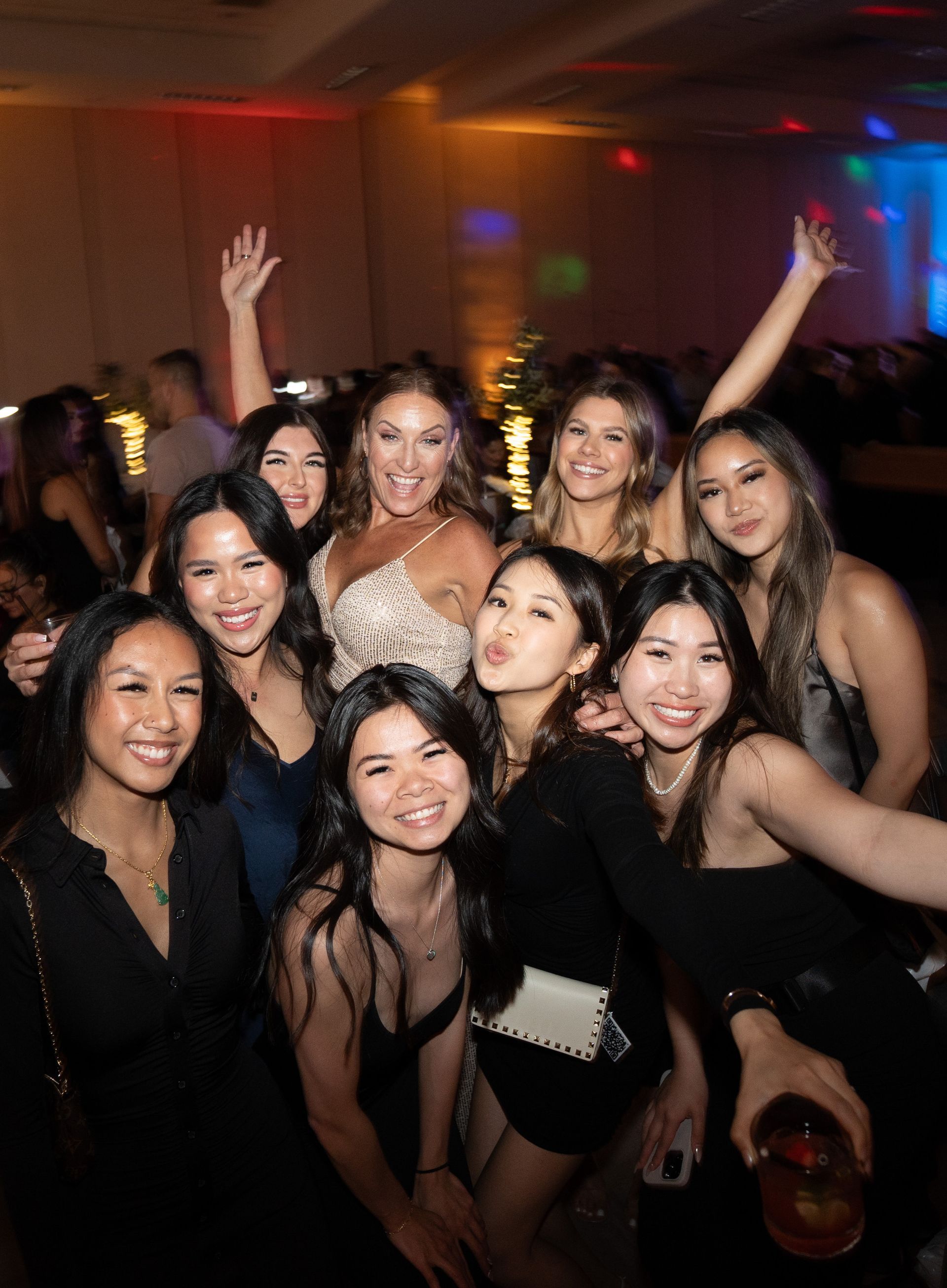 A group of women are posing for a picture at a party.