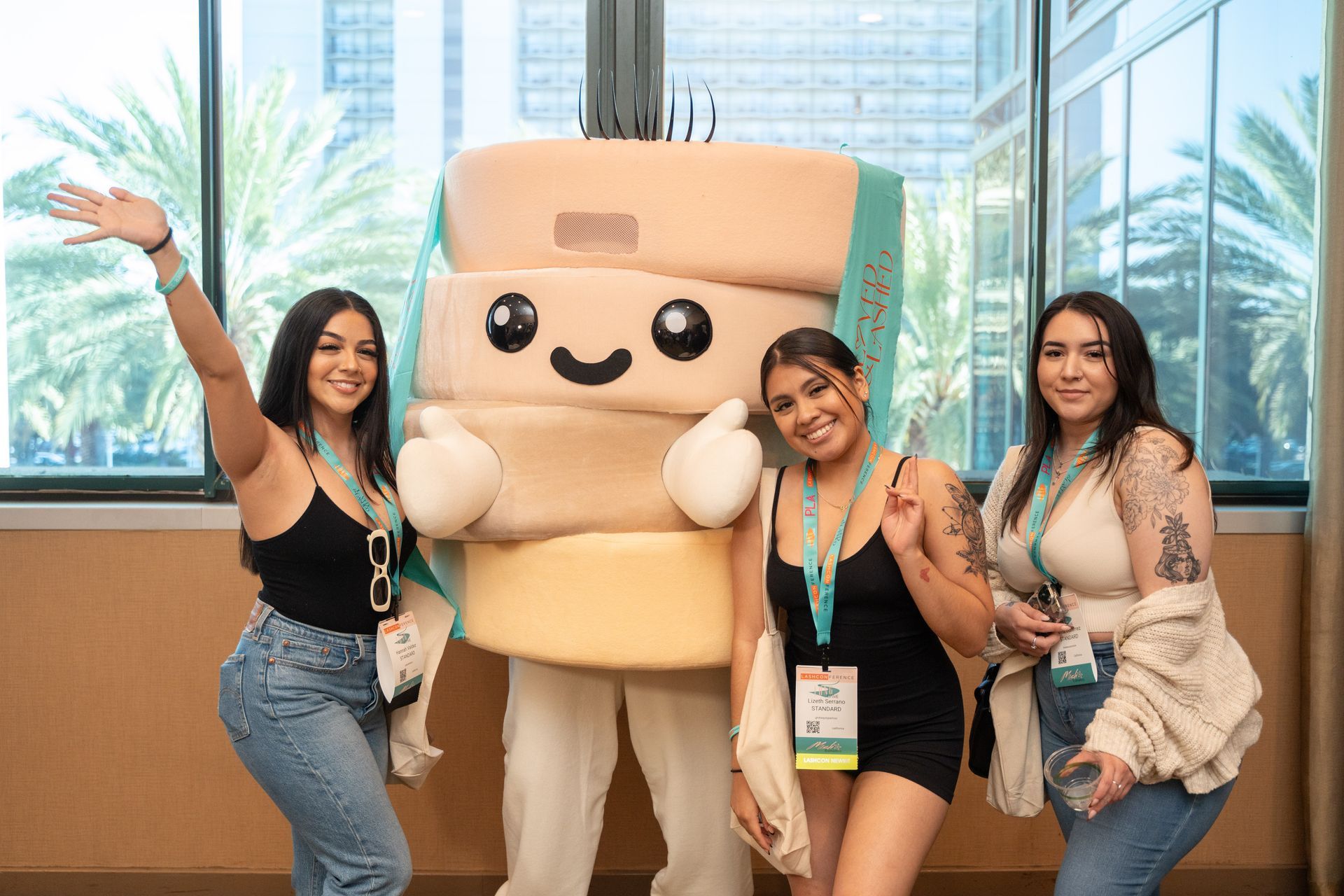 Three women are posing for a picture with a mascot.