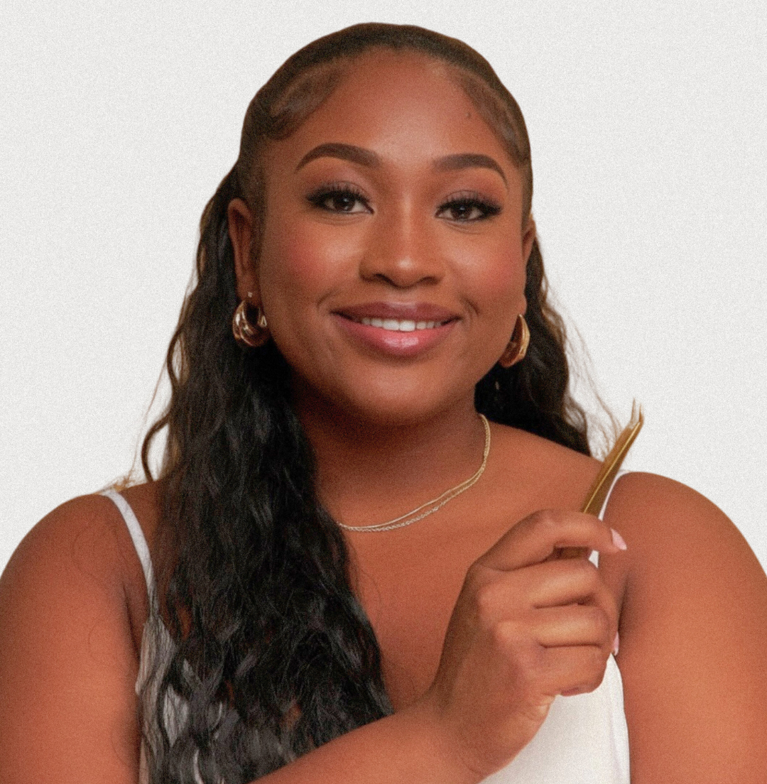 A woman with long hair is smiling and holding a comb