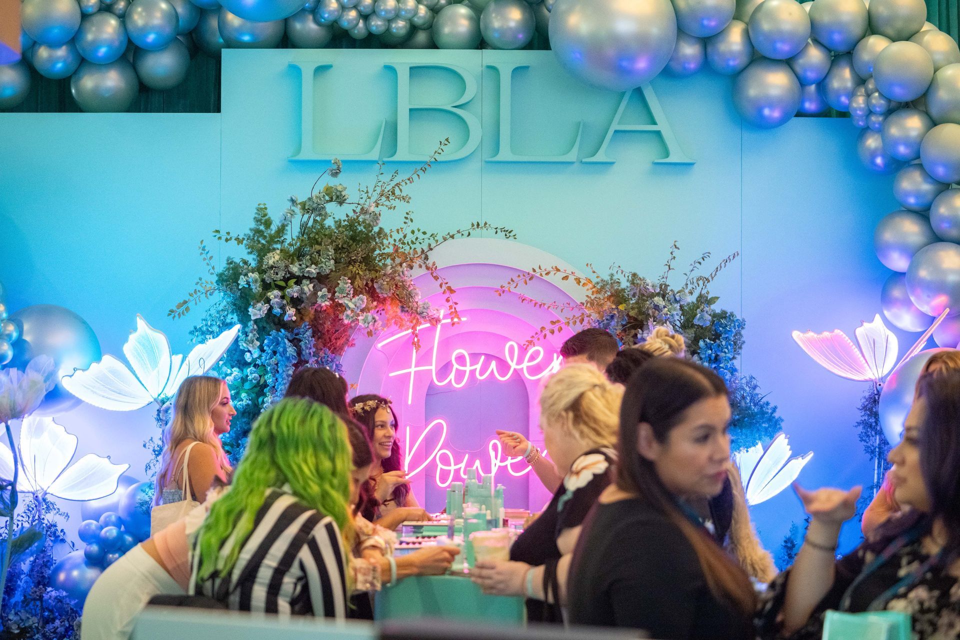 People gather in front of a blue 