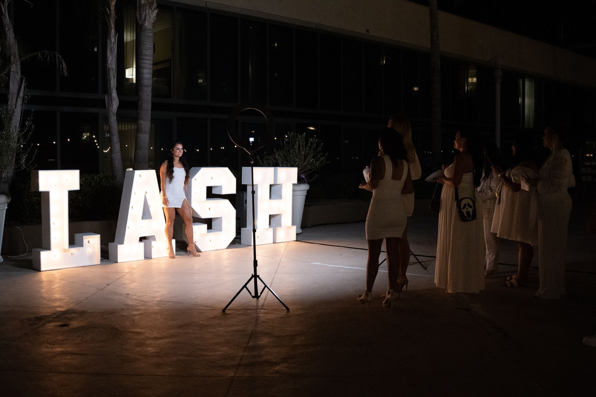 A group of people standing in front of a sign that says lash.