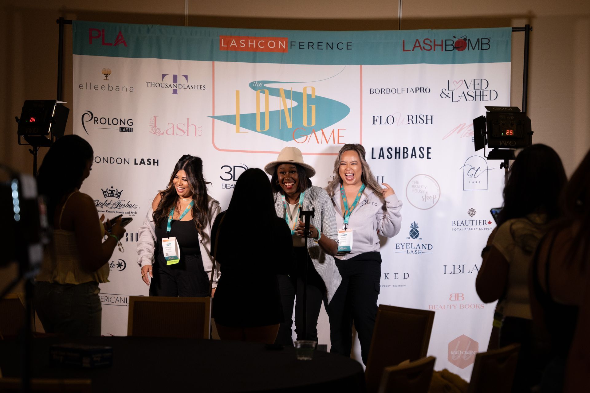 A group of women are standing in front of a projector screen at a conference.