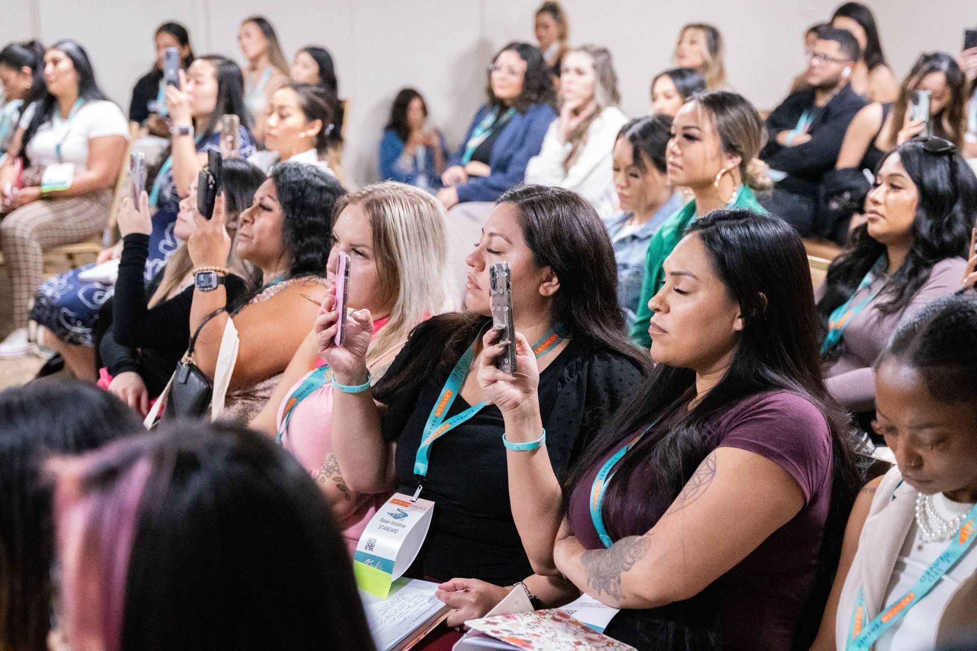 A group of women are sitting in a classroom watching a presentation.