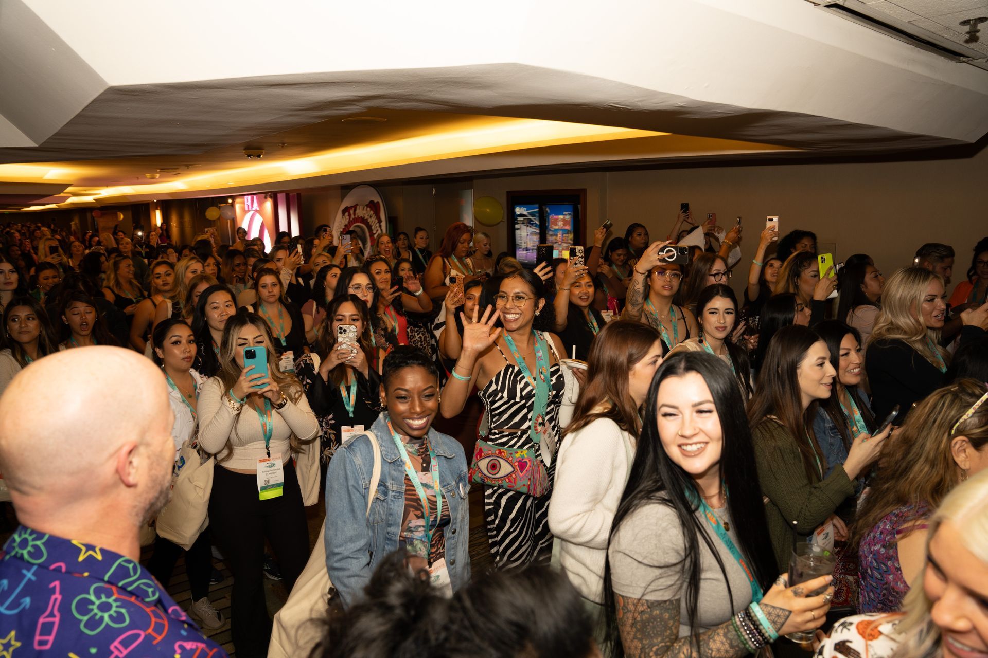 A large group of people are standing in a room.