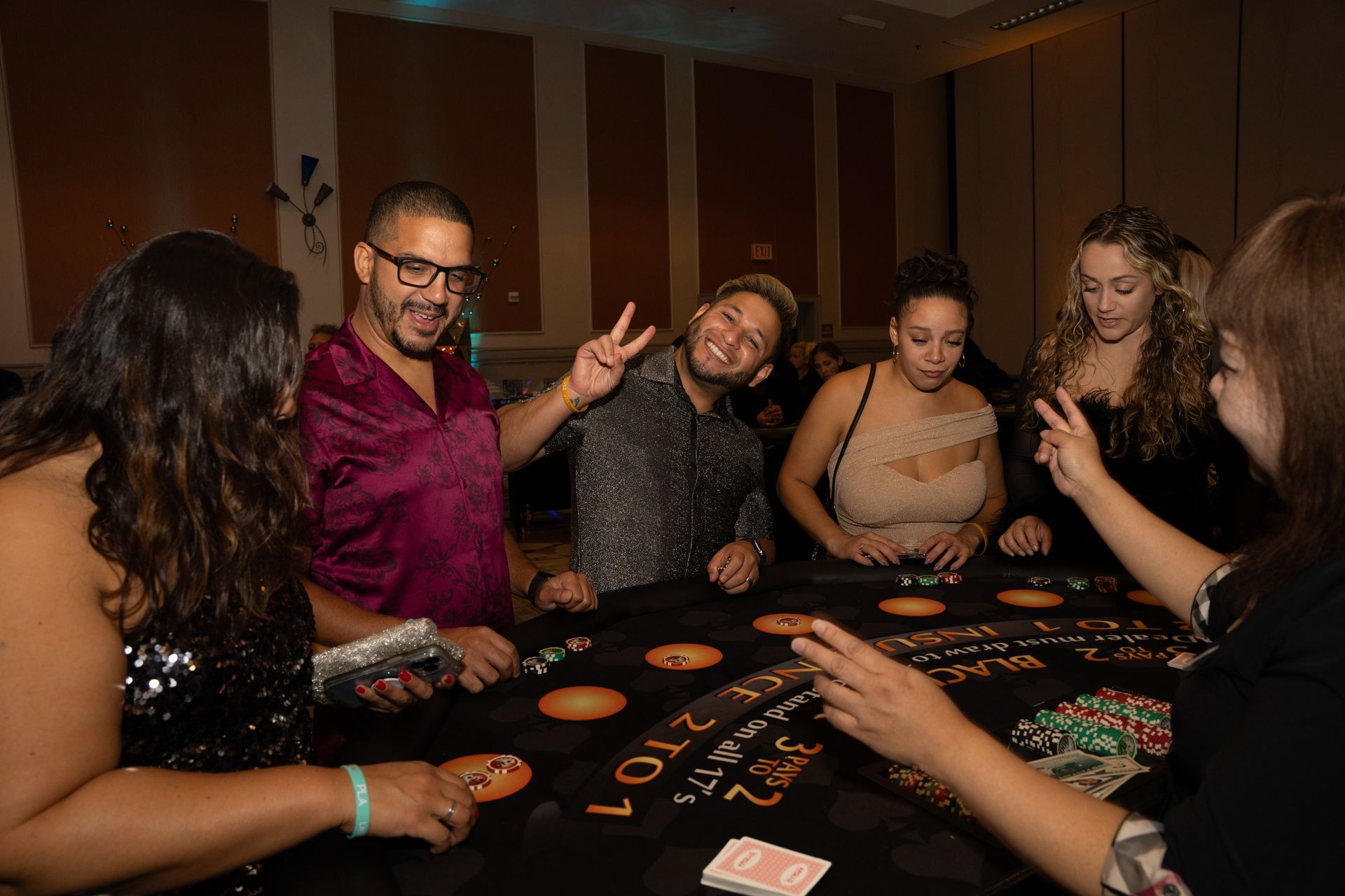A group of people are playing a game of poker at a table.