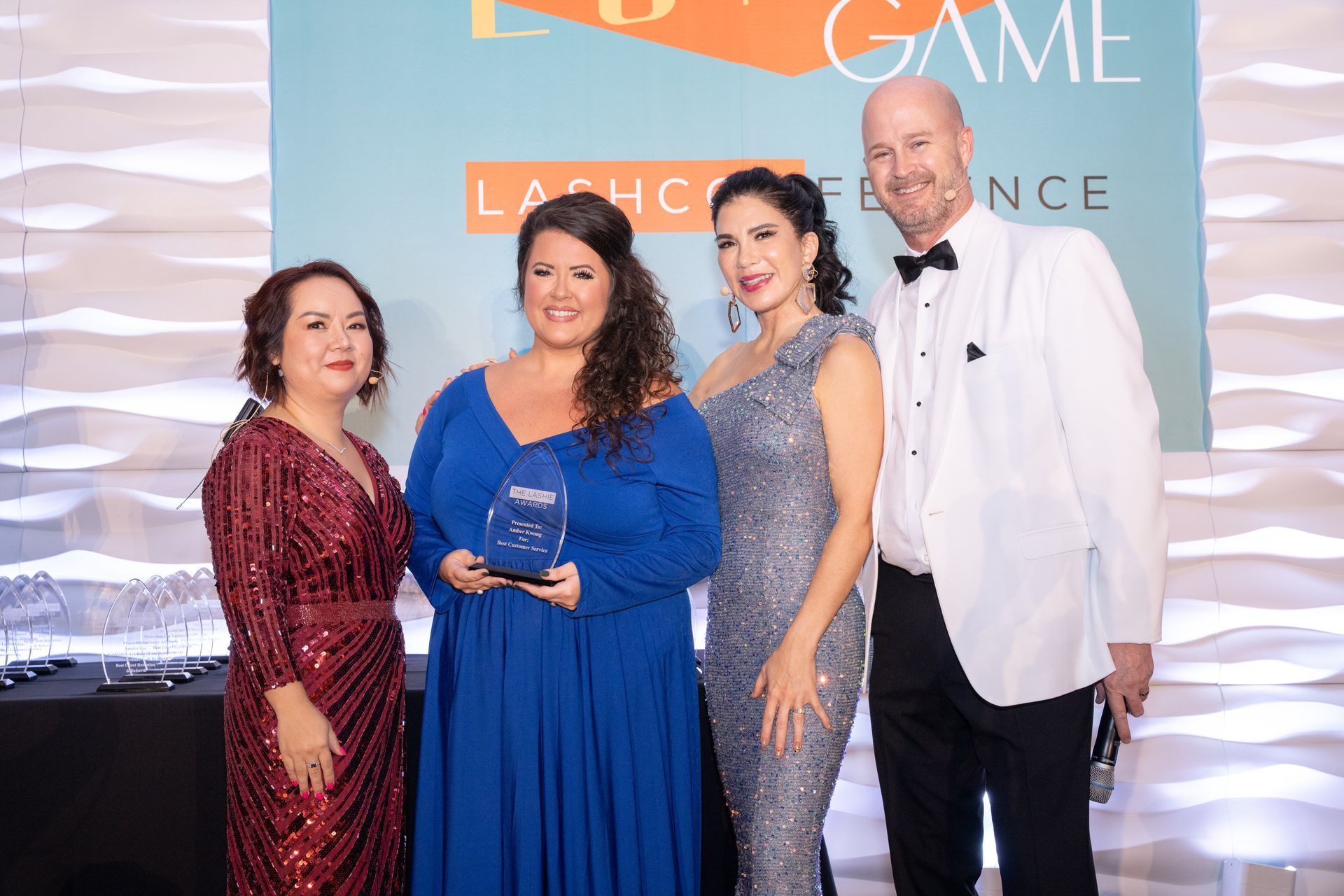 A group of people are posing for a picture at a awards ceremony.