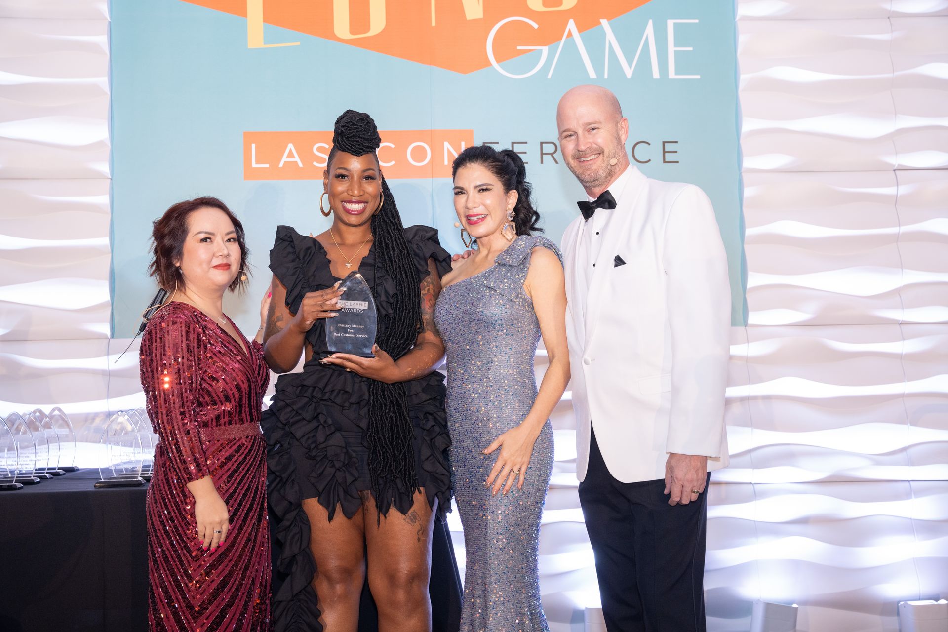 A group of people are posing for a picture at a awards ceremony.