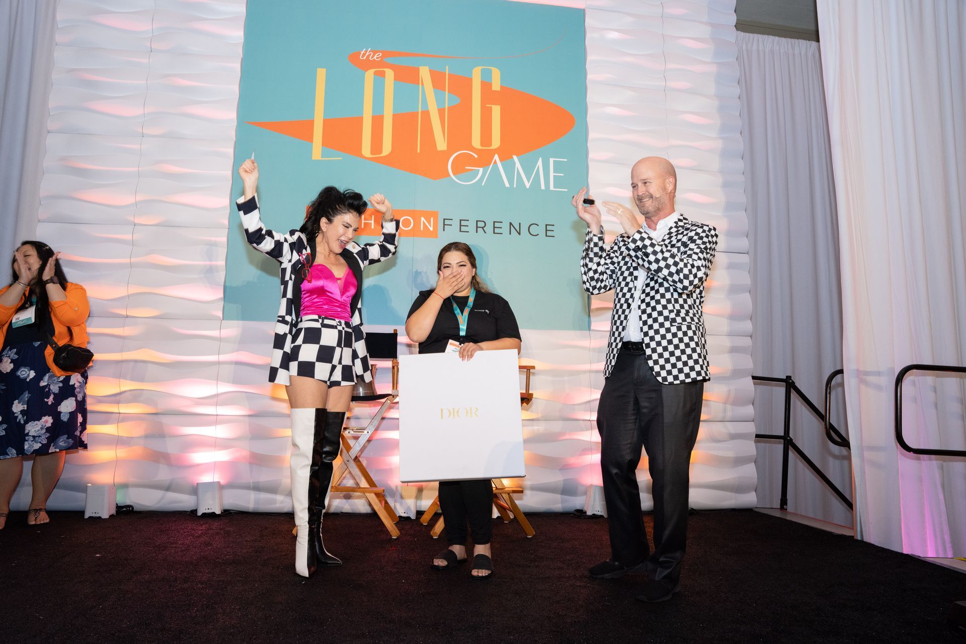 A group of people standing in front of a sign that says live game