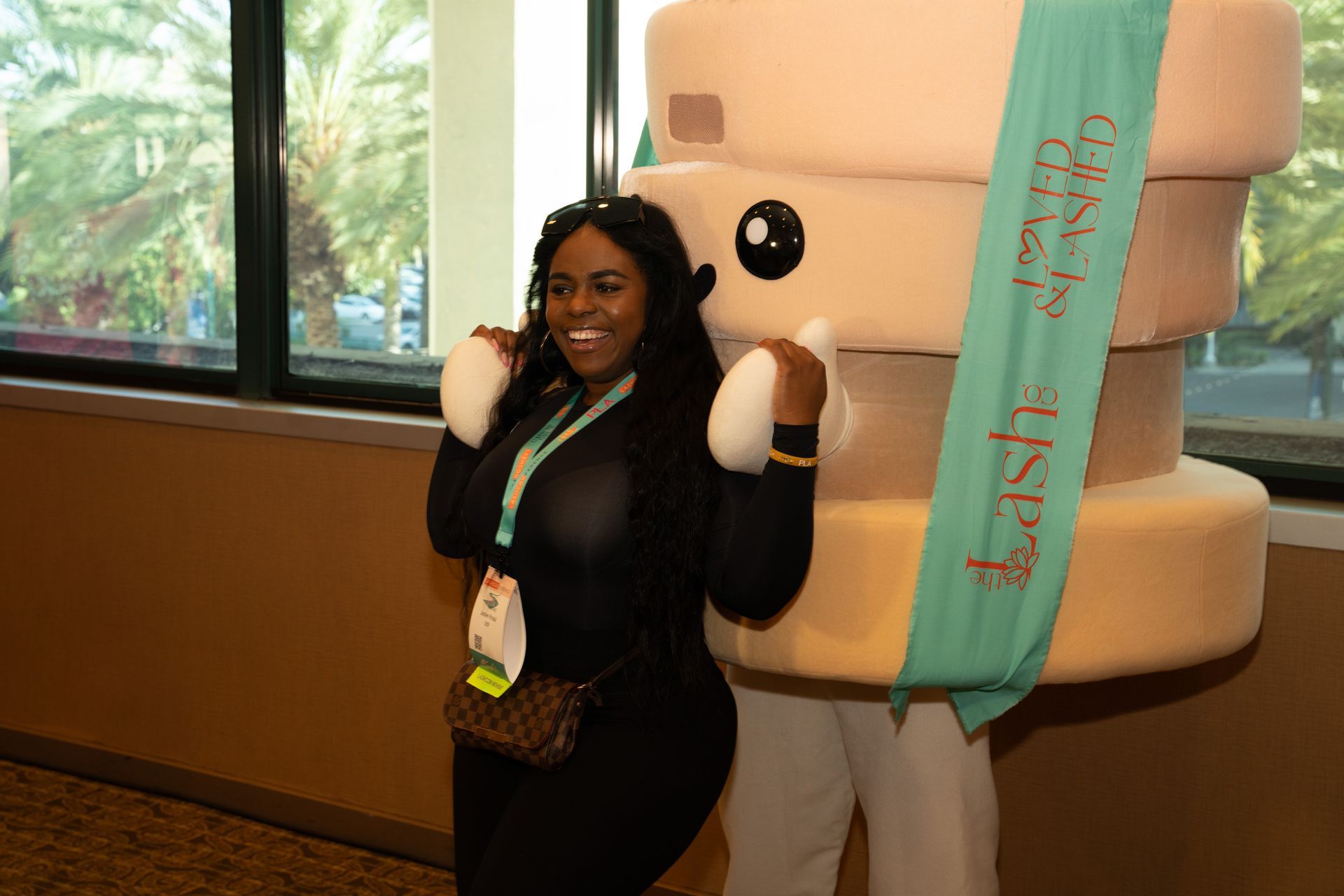 A woman is posing for a picture with a mascot.