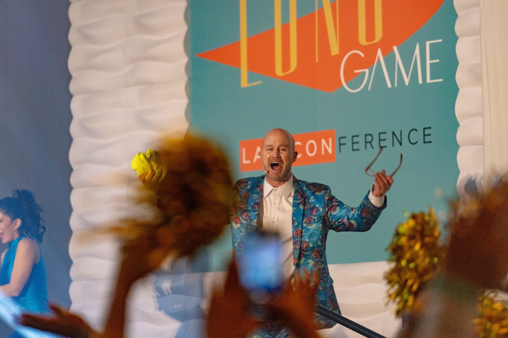 A man in a suit is standing in front of a sign that says lund game.