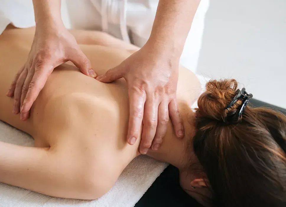 A woman is getting a massage on her back at a spa.