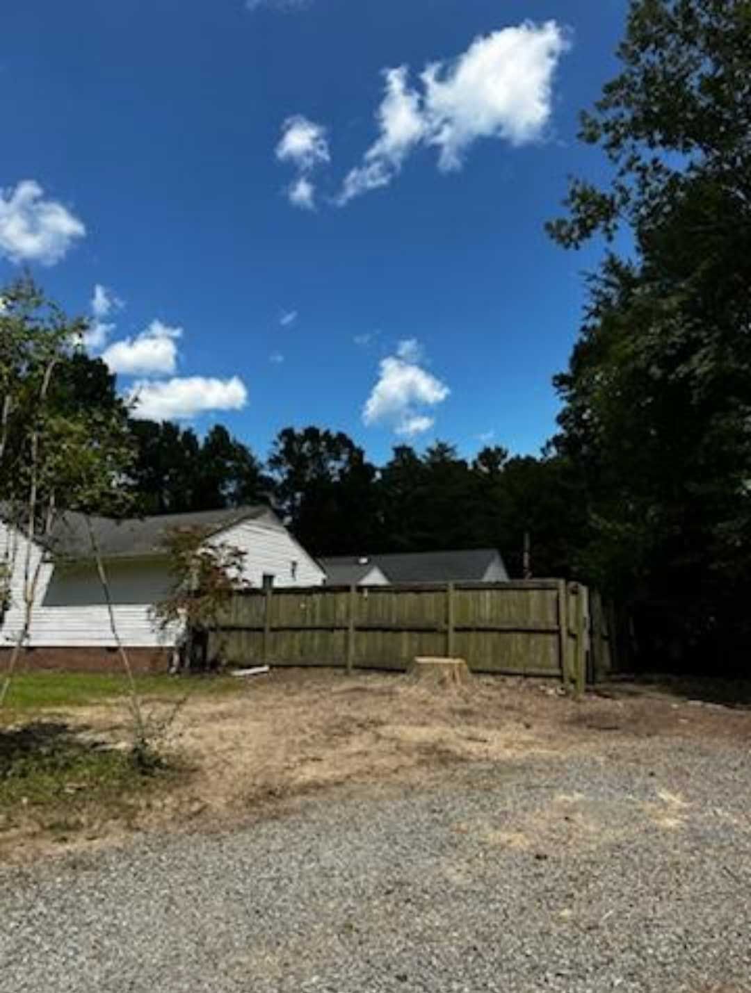 A house with a wooden fence in front of it
