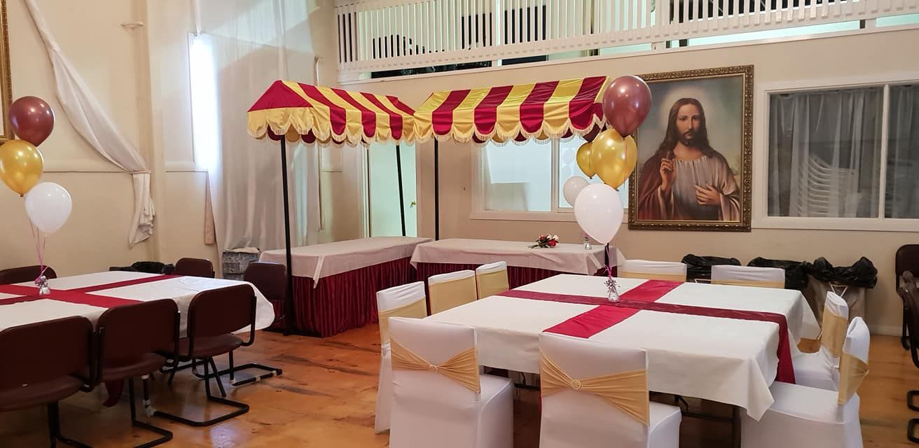 A room with tables and chairs and a picture of jesus on the wall.
