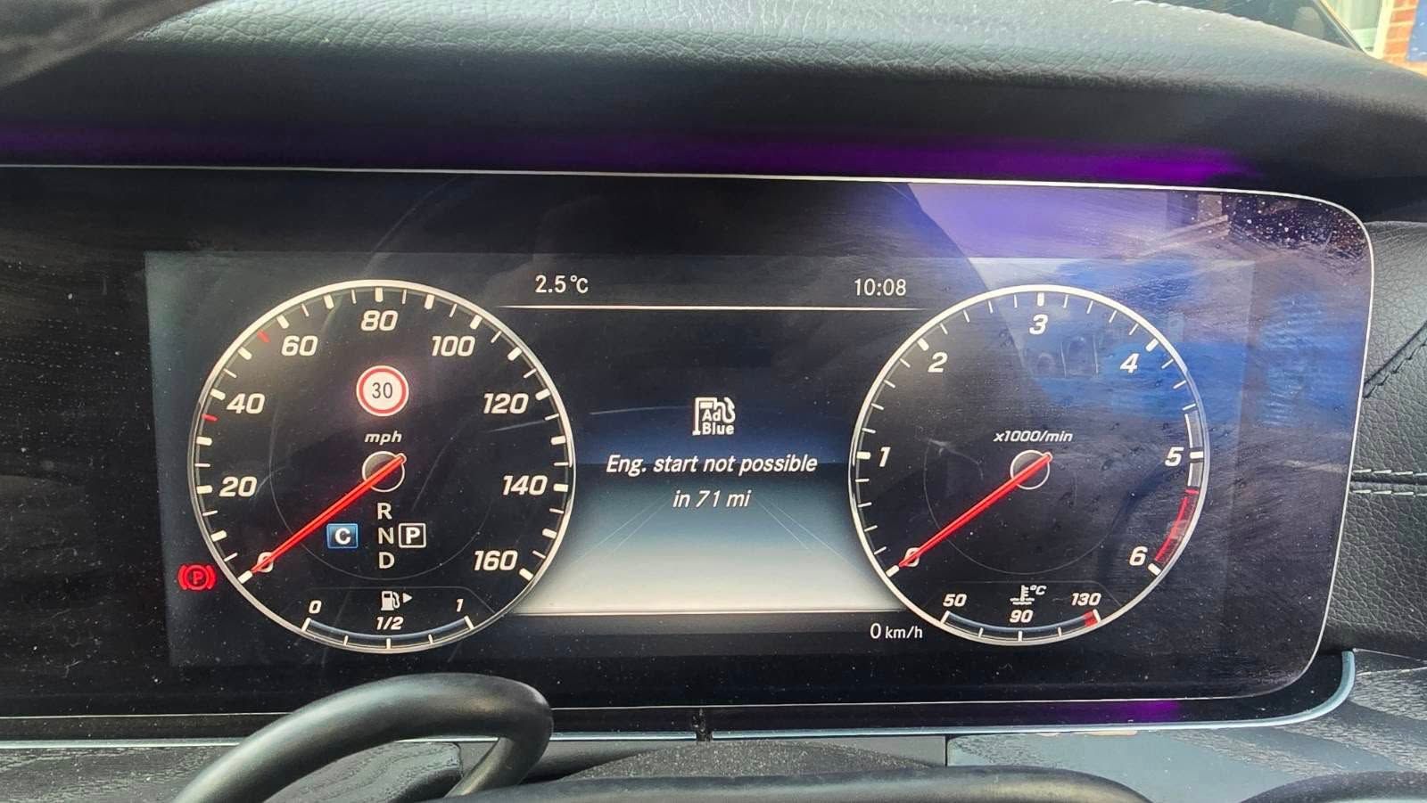 Dashboard with speedometer, tachometer, fuel gauge, and warning lights.