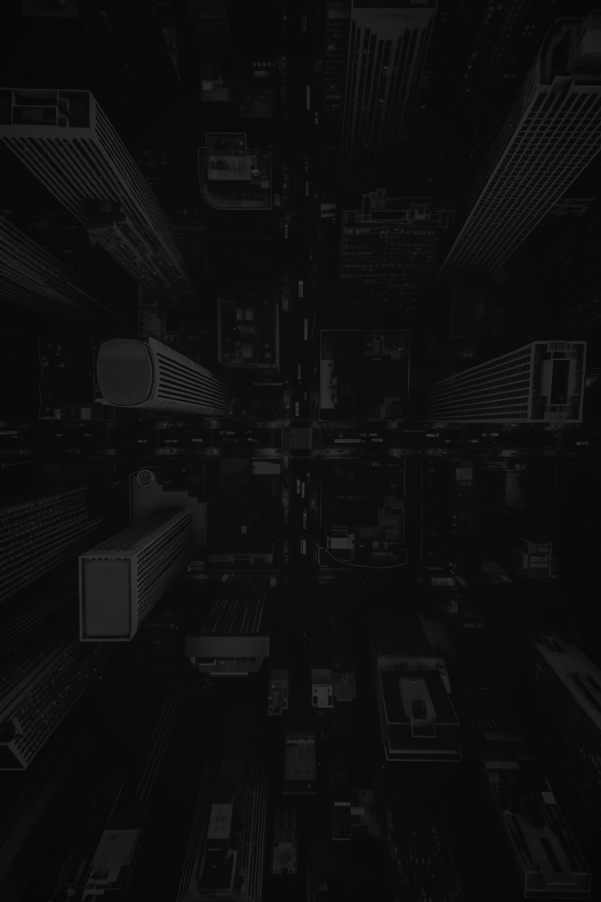 Cidade escura com arranha-céus imponentes, vista de cima, criando um padrão semelhante a uma grade.