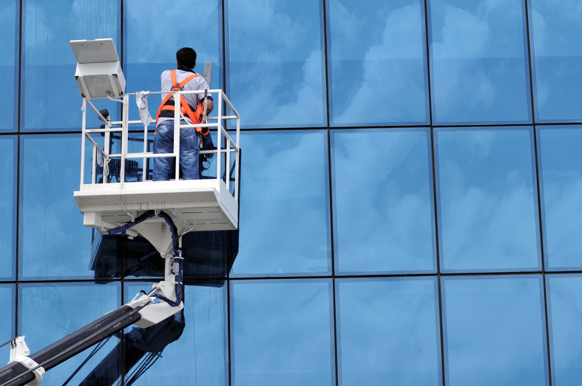 Man Cleaning Windows — Haute, IN — TBM Building Services