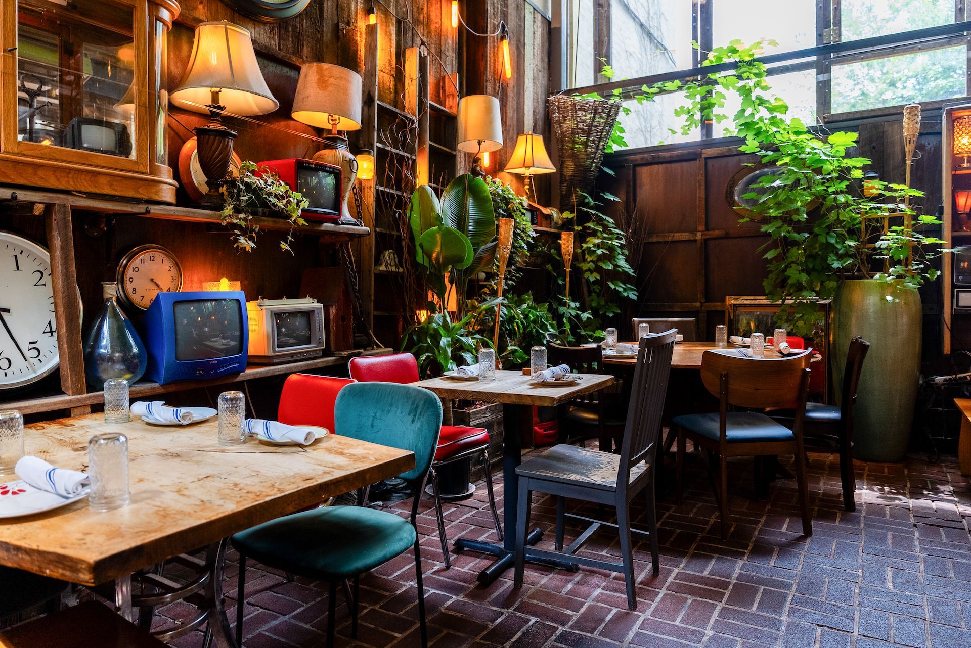 A restaurant with tables and chairs and a clock on the wall.