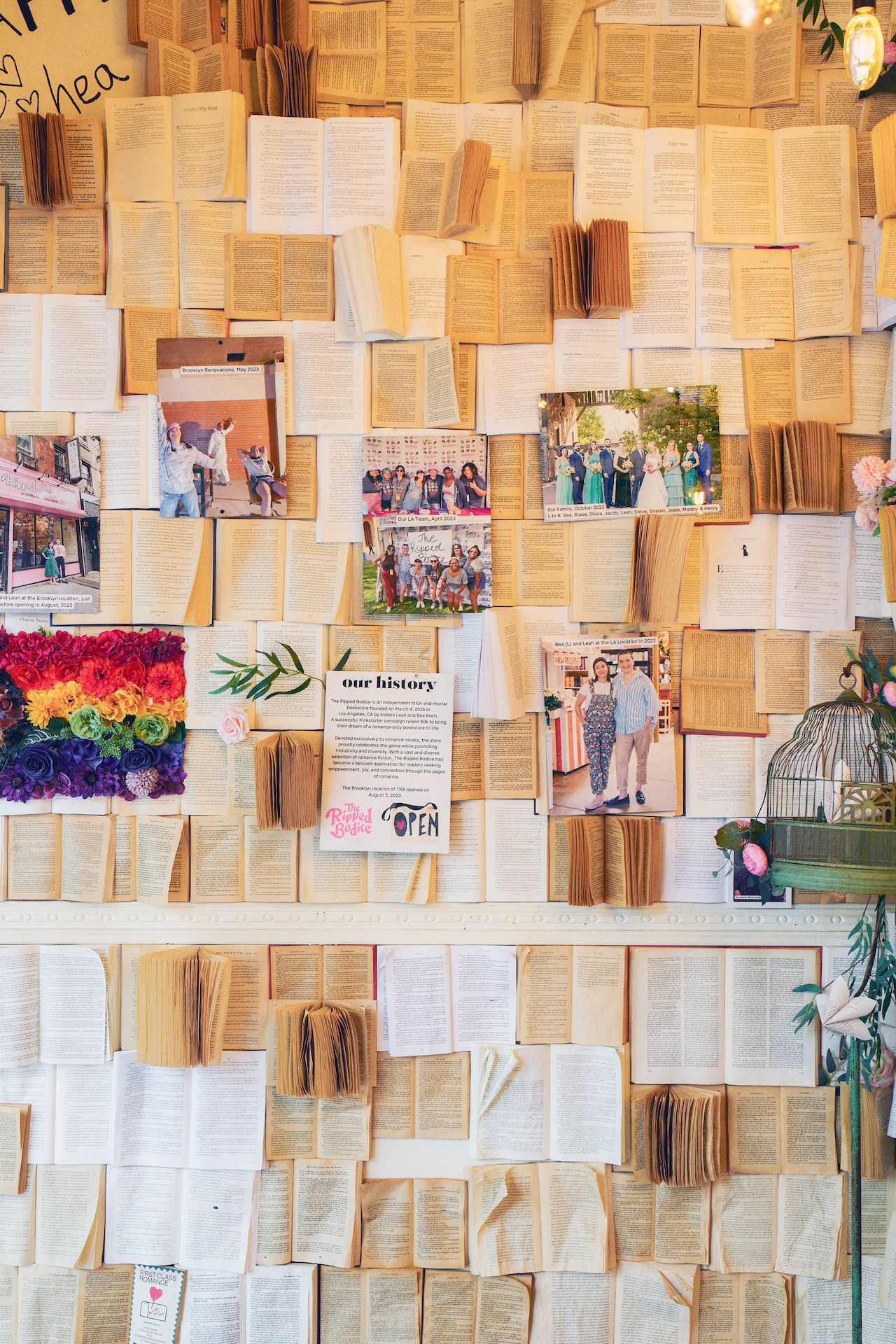 A wall filled with lots of books and pictures.