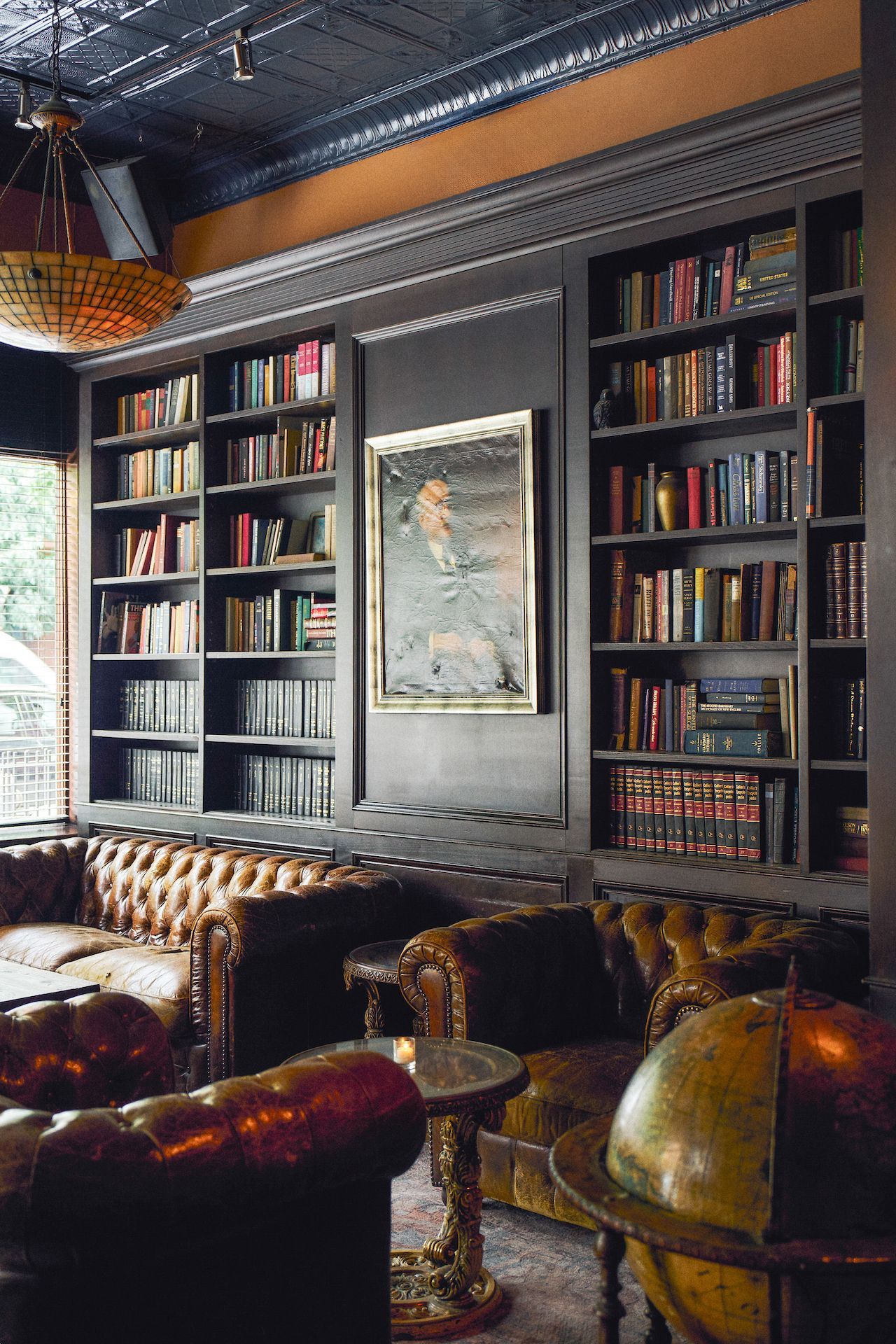 A room with a lot of books on the shelves