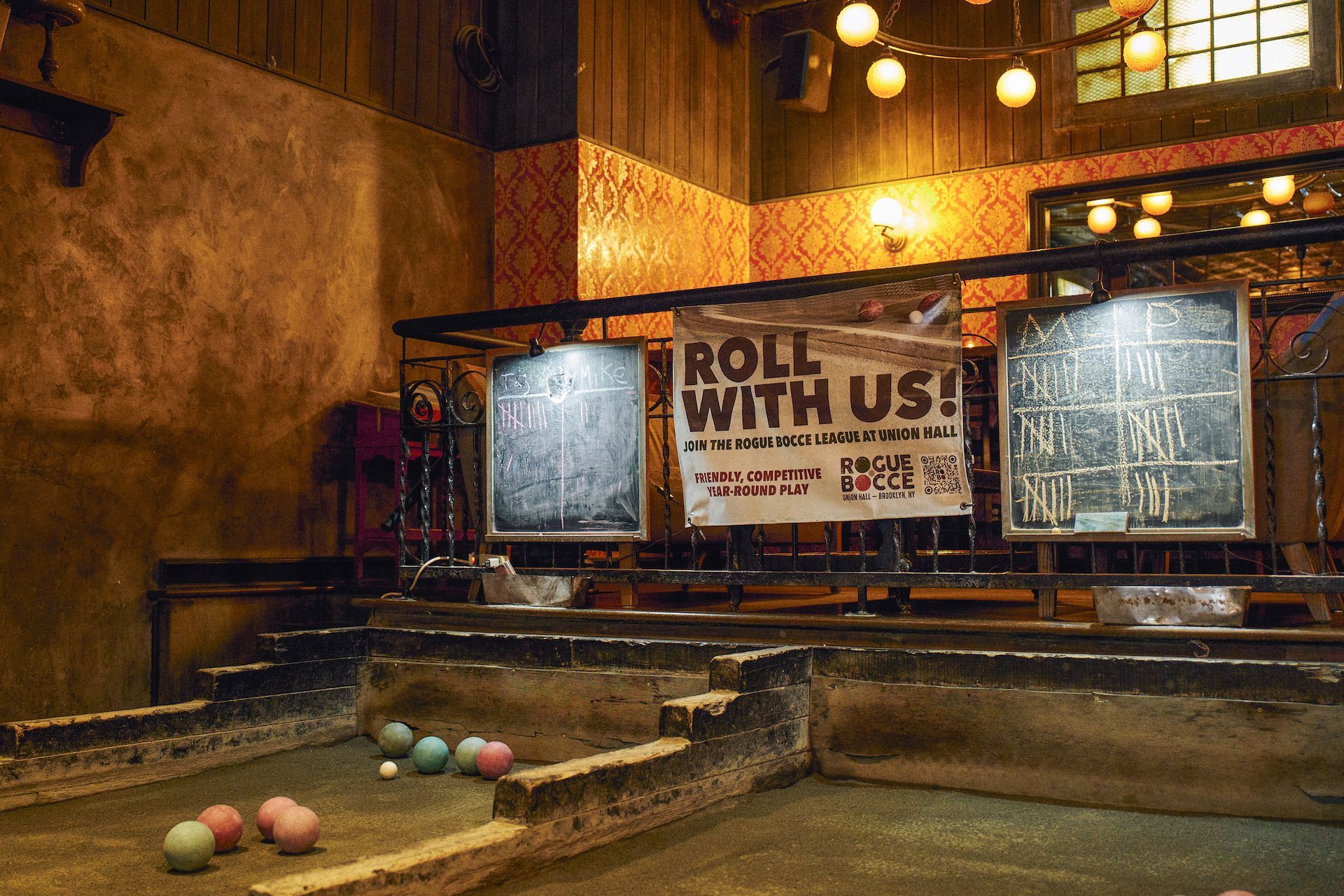A bowling alley with a sign that says roll with us
