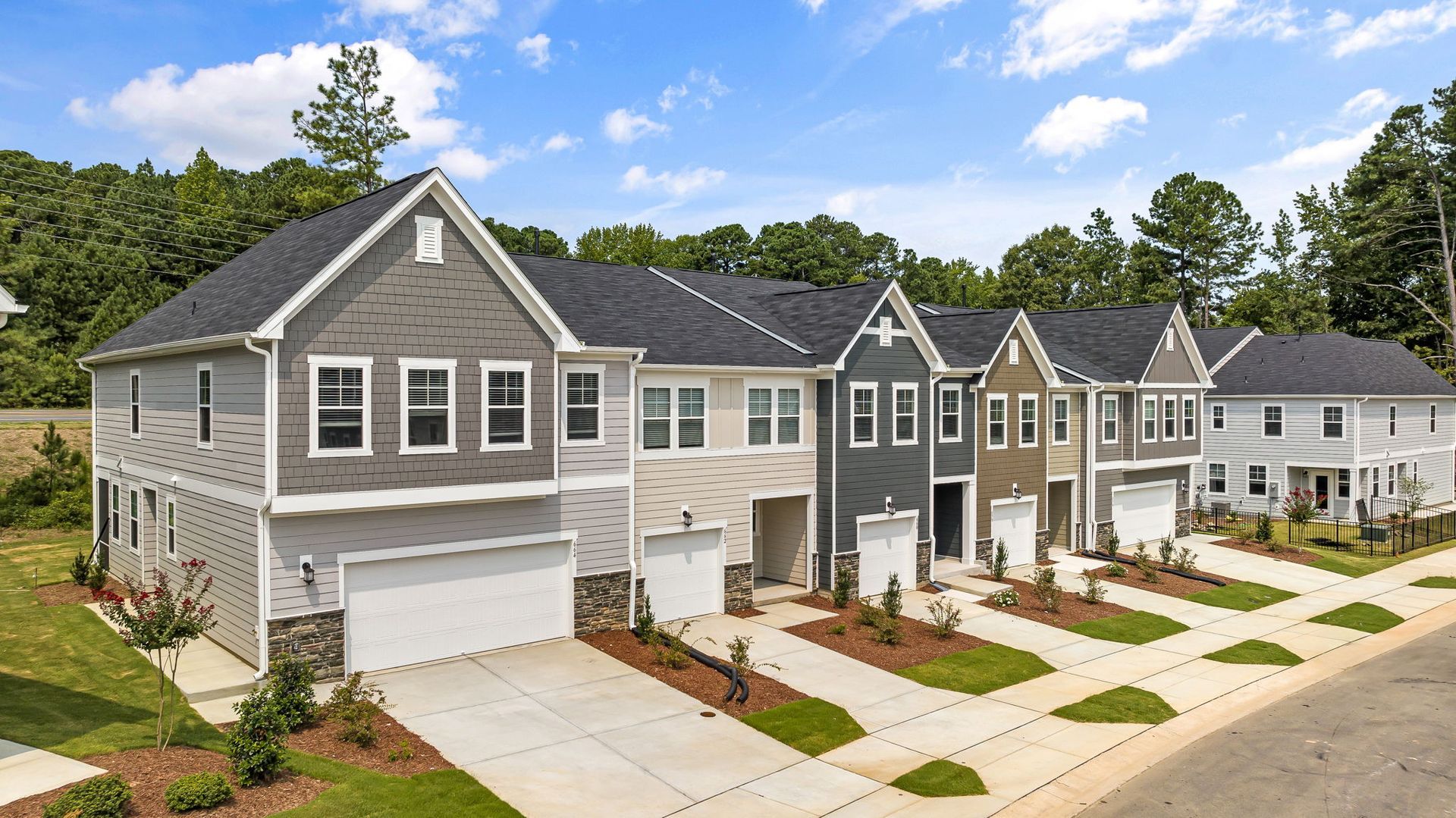 a row of houses are lined up next to each other in a residential area .