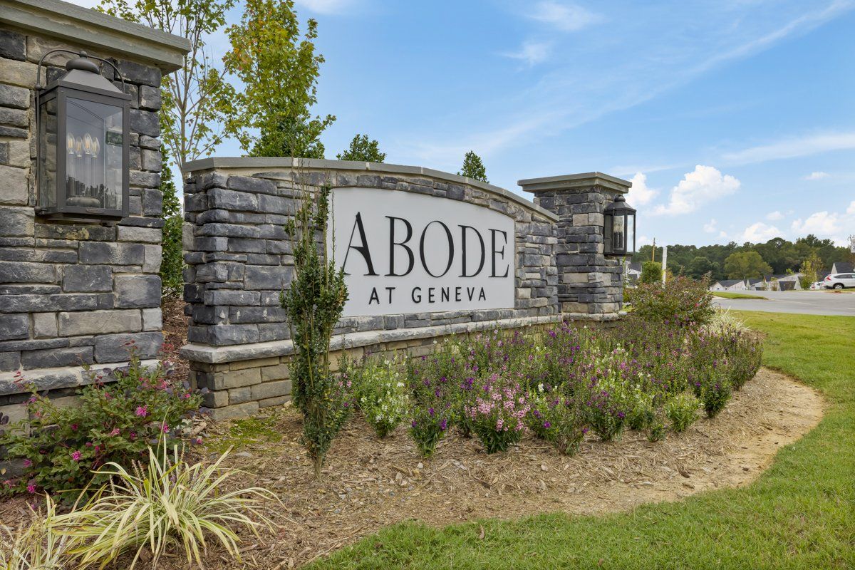 a stone wall with a sign that says abode at geneva on it .