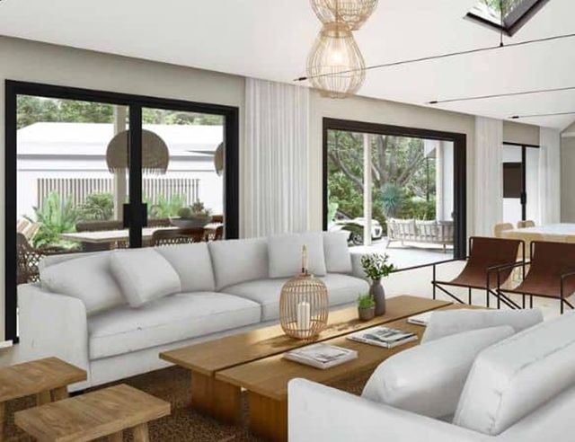 A living room with two white couches and a coffee table