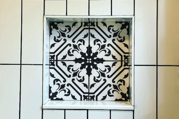 A black and white tile in a shower niche