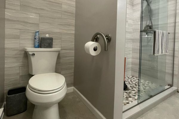 There is a toilet and a shower in the bathroom.
