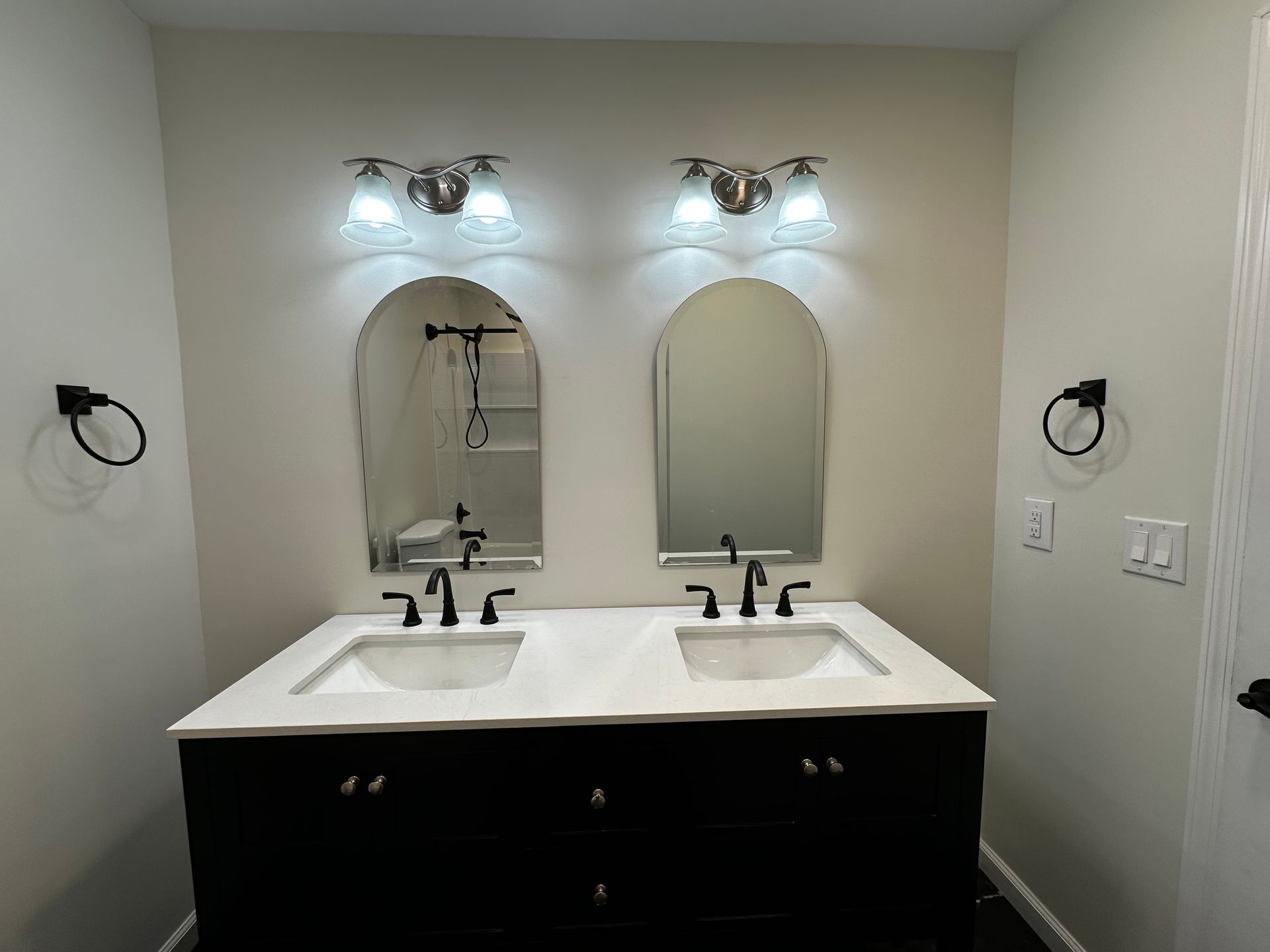 A bathroom with two sinks and two mirrors.