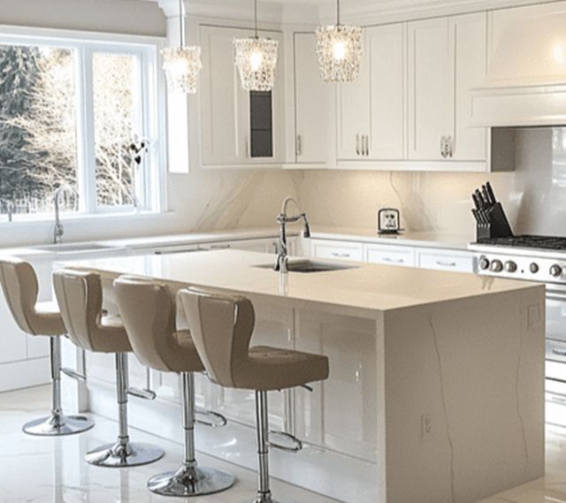 A kitchen remodel with white cabinets , a large island , stools, and a stove. A kitchen remodel with white cabinets , a large island , stools, and a stove.