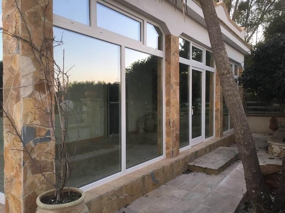 Edificio con ampie vetrate, esterno in pietra, che riflette l'esterno.