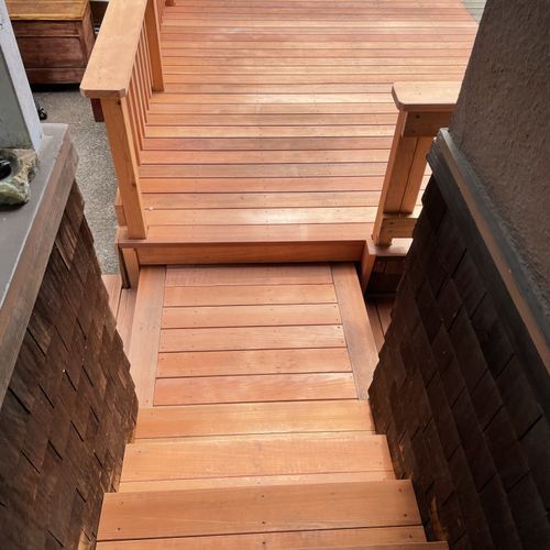 A wooden deck with stairs leading up to it