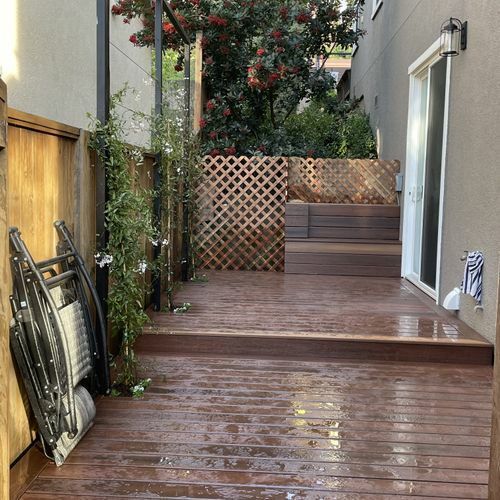 A wooden deck with stairs leading up to it