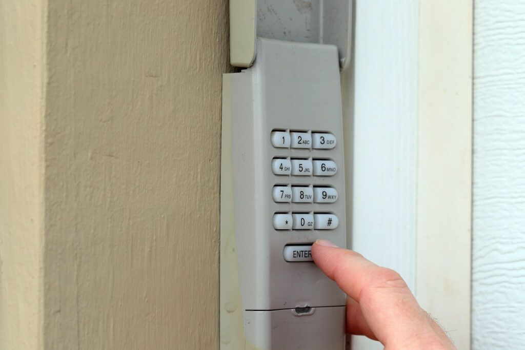 A person is pressing a button on a keypad.