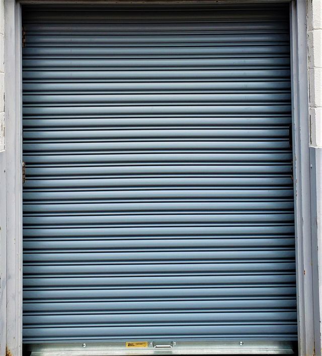 A close up of a blue roller shutter on a building.