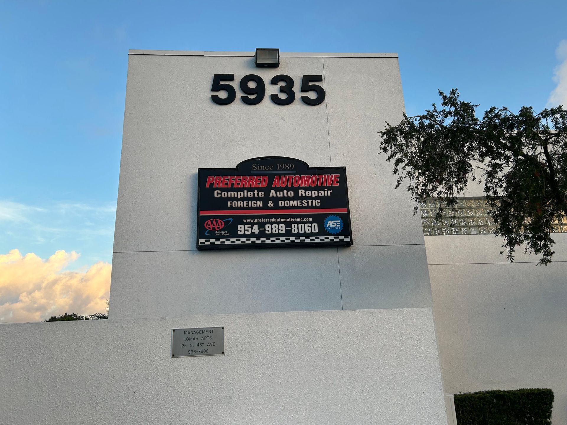 Building facade with address 5935 and a sign for auto repair services.