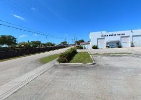 A street scene with a white building labeled