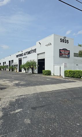 Preferred Automotive building with open garage door and address 5935.
